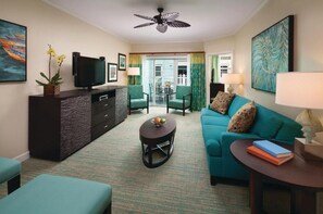 Relax in a stylish seating area with a sofa, armchairs, and flat-screen TV.