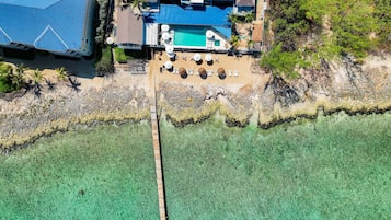 Situated by a tranquil body of water, this coastal property offers a swimming pool and sun loungers.