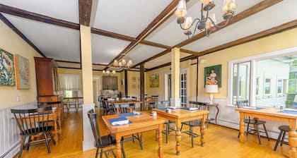 Comfortable budget room with queen bed, street view, and all-glass shower stall with full service breakfast included