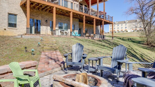 A building with a covered patio area featuring outdoor seating and a fire pit. - Large Tazewell Home < 1 Mi to Norris Lake Access! (Tazewell)