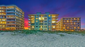 A beachfront hotel with multiple floors, balconies, and a beach view. - New Beautiful 3bed/2bath Beachfront Condo! (Orange Beach)