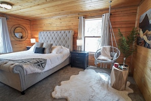 Main floor primary bedroom: luxurious king bed, hotel quality linens/pillows