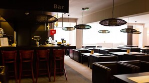 A restaurant interior with a bar area, multiple seating arrangements, and hanging pendant lights. - Geovita Dzwirzyno (Kołobrzeg)