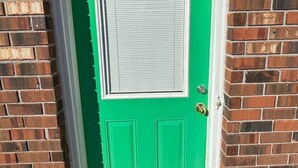 A green door with a white window and a number '1411' above it.