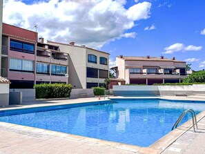 Guests can enjoy a refreshing swim in the pool surrounded by a tiled deck.
