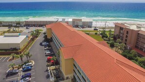 A hotel with a red-tiled roof overlooking a beach and ocean. - Private Beach Access! Free Activities Fun Pass! Ciboney 4013! (Miramar Beach)