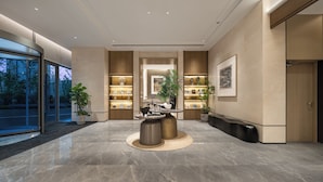 A modern lobby with a marble floor, a central seating area, and a reception desk. - Somerset Pudong Riverside Shanghai (Shanghai)