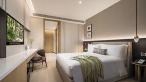 A modern hotel room with a large bed, a desk, and a television. - Somerset Pudong Riverside Shanghai (Shanghai)