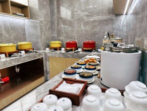A buffet setup with various dishes and a coffee machine. - Somerset Pudong Riverside Shanghai (Shanghai)