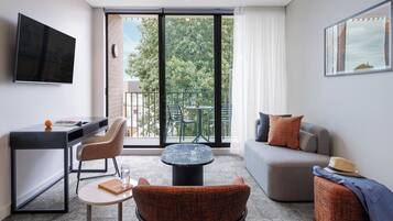 Superior One Bedroom Apartment with Balcony | Living area | 55-inch Smart TV with satellite channels, Netflix, streaming services