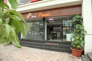 A hotel entrance with a sign reading 'Pearls.' - Hotel Pearls (Chhatrapati Sambhajinagar)