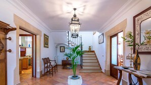 A spacious hallway with a tiled floor, a staircase, and a dining area visible in the background. - Villa Sanchez (Campos)