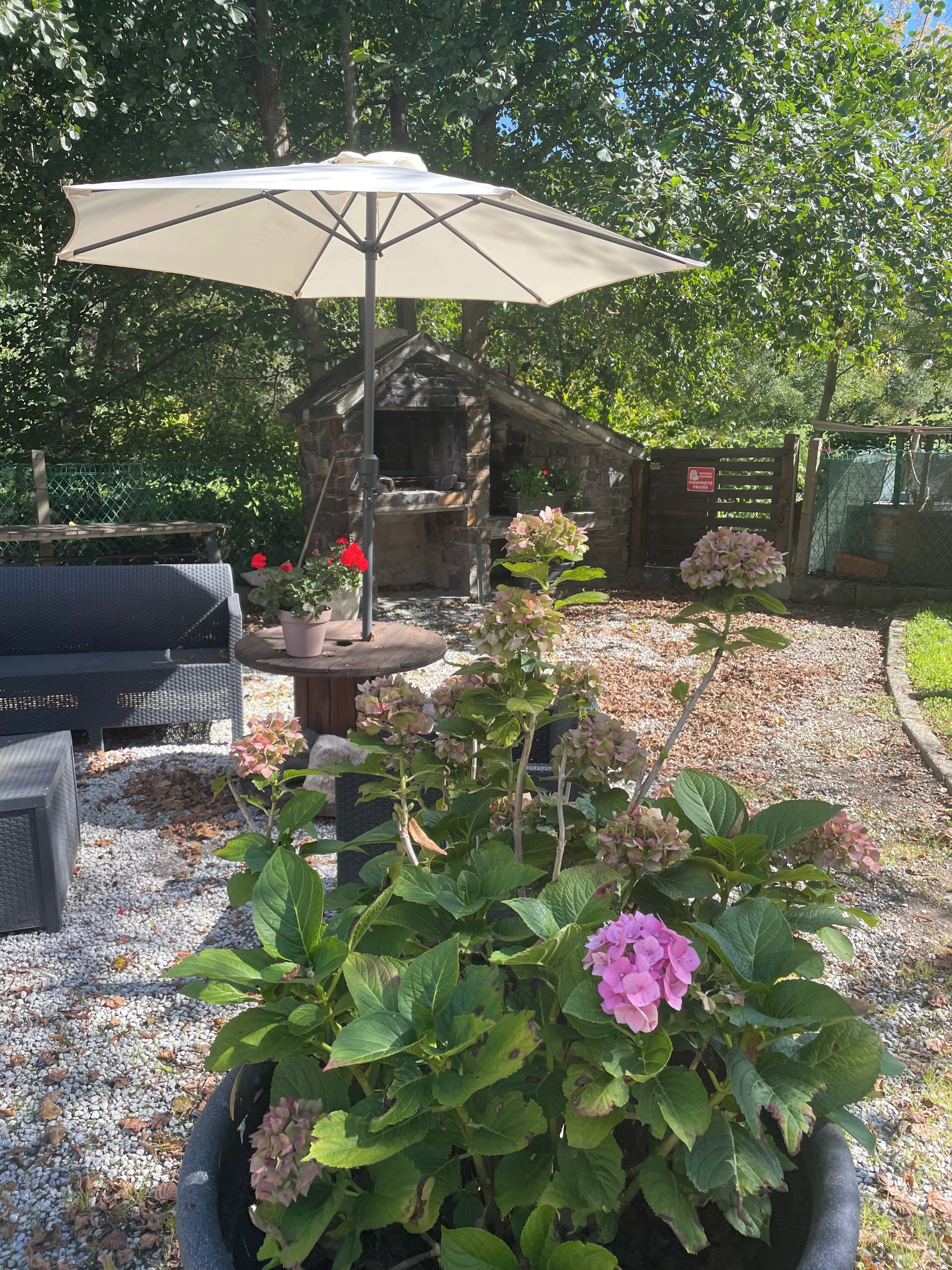 Garden with rustic stone BBQ (all year) next to stream with seating area (summer only)