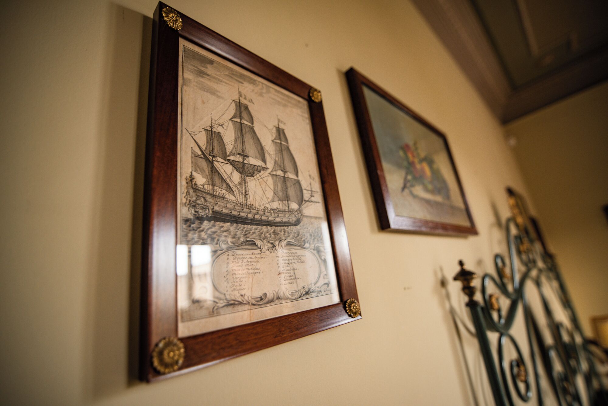 Dos ilustraciones históricas marítimas enmarcadas en una pared.