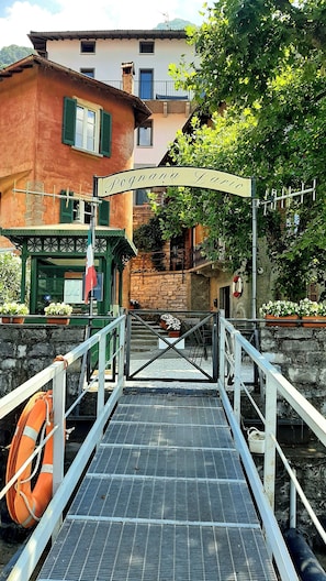 A bridge leading to a building with a sign reading 'Fognana Largo.'