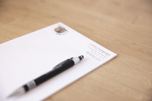 A business card for the Renaissance Hotel on a piece of graph paper with a pen on it.