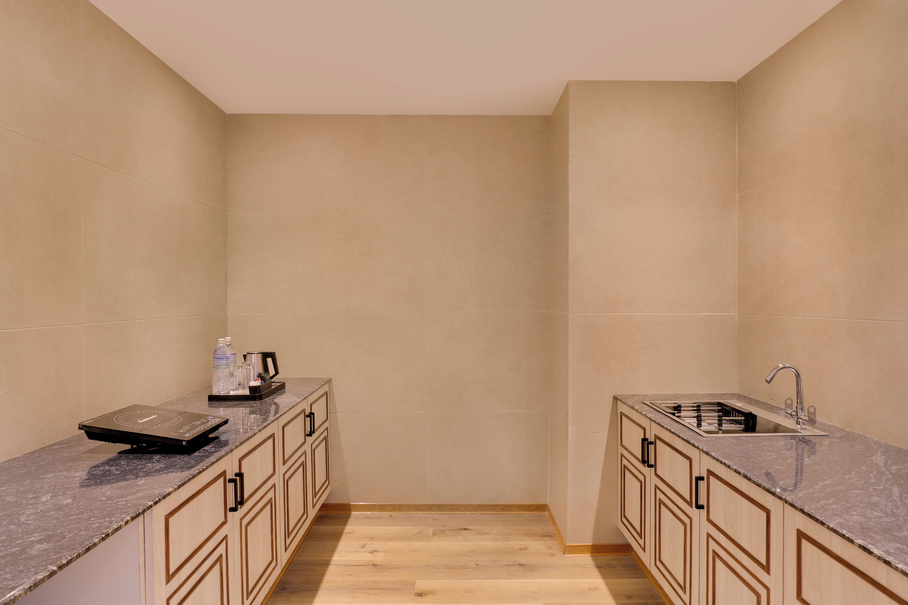 A compact kitchen with two counters, a sink, and a coffee maker.