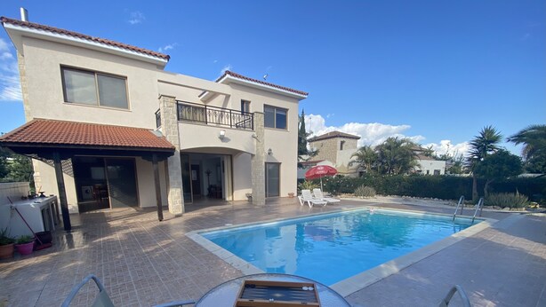 A two-story house with a swimming pool, outdoor seating, and a pergola. - Villa Ariadni - Luxurious Villa with Spectacular Views and Private Pool! (Pissouri)