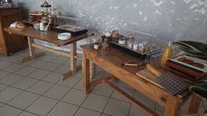 A breakfast buffet setup with various food items and condiments on wooden tables. - Logis Hôtel le Clos Saint-Loup (Bram)