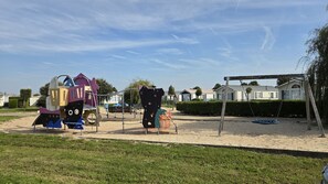 A playground with climbing structures and a swing set in a residential area. - Fisherman's cottage in Wenduine, close to the beach and marina of Blankenberge.  (De Haan)