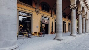 A building with large columns, outdoor seating, and a sign that reads "Ruby". - Ruby Bea Hotel Florence (Florence)