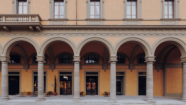 A building with a central courtyard, multiple arches, and a storefront with a sign. - Ruby Bea Hotel Florence (Florence)