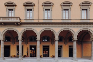 A building with a central courtyard, multiple arches, and a storefront with a sign. - Ruby Bea Hotel Florence (Florence)