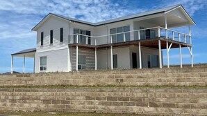 A two-story house with a balcony and a covered porch. - Casa Bianca - Ocean and harbour views (Cape Jaffa)