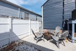 A patio with outdoor furniture and a fire pit. - Large Home w/ Back Yard Oasis | Perfect for Groups (New Orleans)