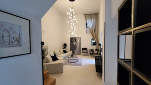A modern living room with a sofa, coffee table, and artwork on the walls. - Casa Al Campanile for Your Relaxing Experience in a Rare Cocktail Pool (Vodnjan)