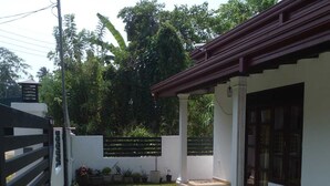 A residential property with a paved patio, a small lawn, and a white exterior wall. - Villa in Yakkala, Gampaha (Yakkala)