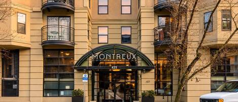 A building with a sign reading 'MONTREUX CONDOMINIUM' at the entrance.