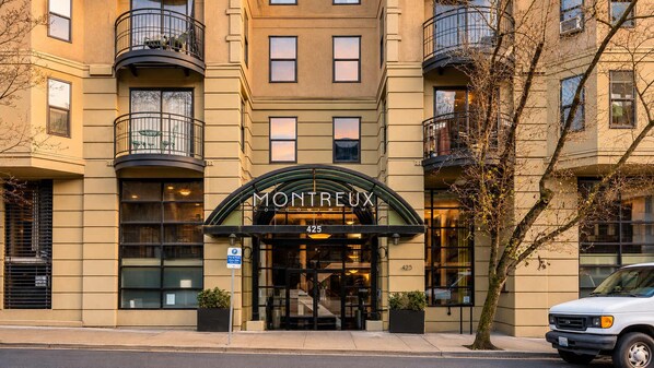 A building with a sign reading 'MONTREUX CONDOMINIUM' at the entrance.
