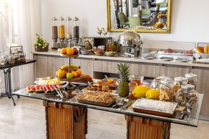 A buffet setup with various food items and condiments. - Stephanos Hotel Apts (Polis)
