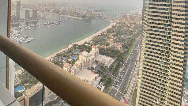 A high-rise building with a view of a marina and cityscape. - Marina Marvel Room Elite Residences (Dubai)