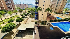 A high-rise building with a rooftop pool and surrounding greenery. - A1039 - Quality flat with garage and swimming pool (Villajoyosa)