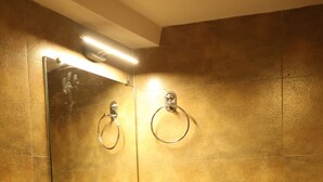 A bathroom with a white sink, a mirror, and a towel ring. - Hotel Air Stay Inn (Mumbai)