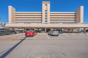 A multi-story parking structure with several cars parked underneath.