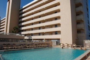 A multi-story hotel with a swimming pool and sun loungers. - Oceanfront condo at Southpoint unit 606 (Ponce Inlet)