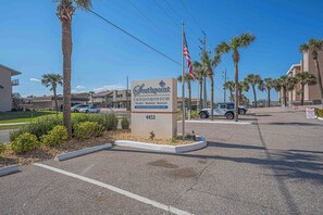 A Southpoint condo sign with a website URL, a phone number, and a flag.