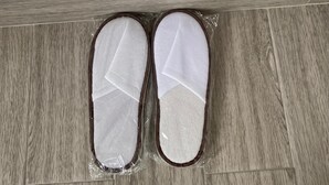 A pair of slippers on a wooden floor. - Luckysmallie 1-bed Apartment in Goba (Dar es Salaam)