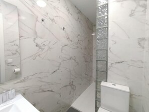Appartement | Badkamer | Een douche, een haardroger, handdoeken, zeep