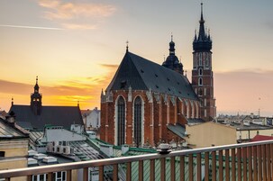 A historic church with a prominent tower and large windows, surrounded by other buildings.