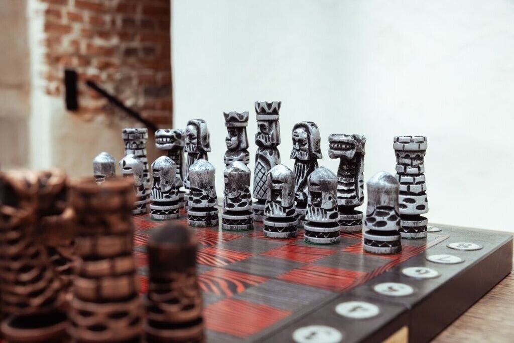 A chessboard with unique, intricately designed pieces.
