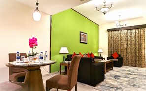 Family Suite, 2 Bedrooms, Kitchen | Living area | 50-inch LED TV with cable channels