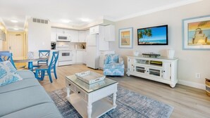 A modern living room with a sofa, coffee table, and dining area. - South Seas Bayside Villa 5226 1 Bedroom Condo by RedAwning (Captiva)