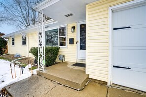 A single-story house with a front porch, a garage door, and a small front yard. - Damaged Shower (Kalamazoo)