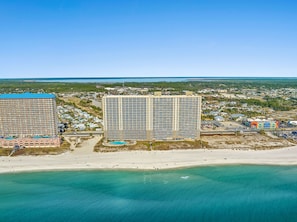 A coastal area with a large hotel, a beach, and a clear view of the ocean. - FREE Beach Service, Golf + Perks! Emerald Beach 1430 Pool, Hot Tub &Starbucks (Panama City Beach)