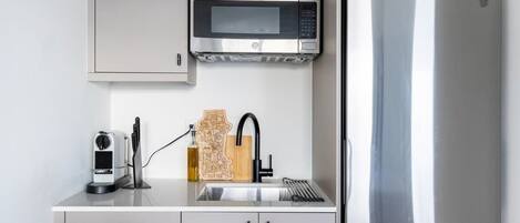 Fridge, microwave, coffee/tea maker, cookware/dishes/utensils