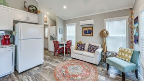 A compact living space with a kitchen, dining area, and seating area. - Vilonia Country Cabin w/ Grill, Fire Pit + More! (Vilonia)